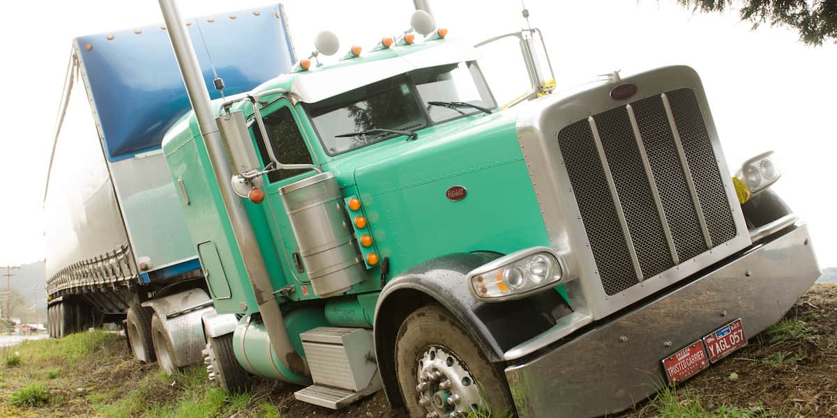 Semi truck accident scene showing damaged vehicles with legal responsibility concepts for truck accident lawsuits