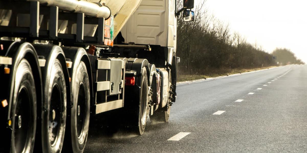 Rear view of a truck driving on a highway, illustrating the risks that can lead to a truck accident claim